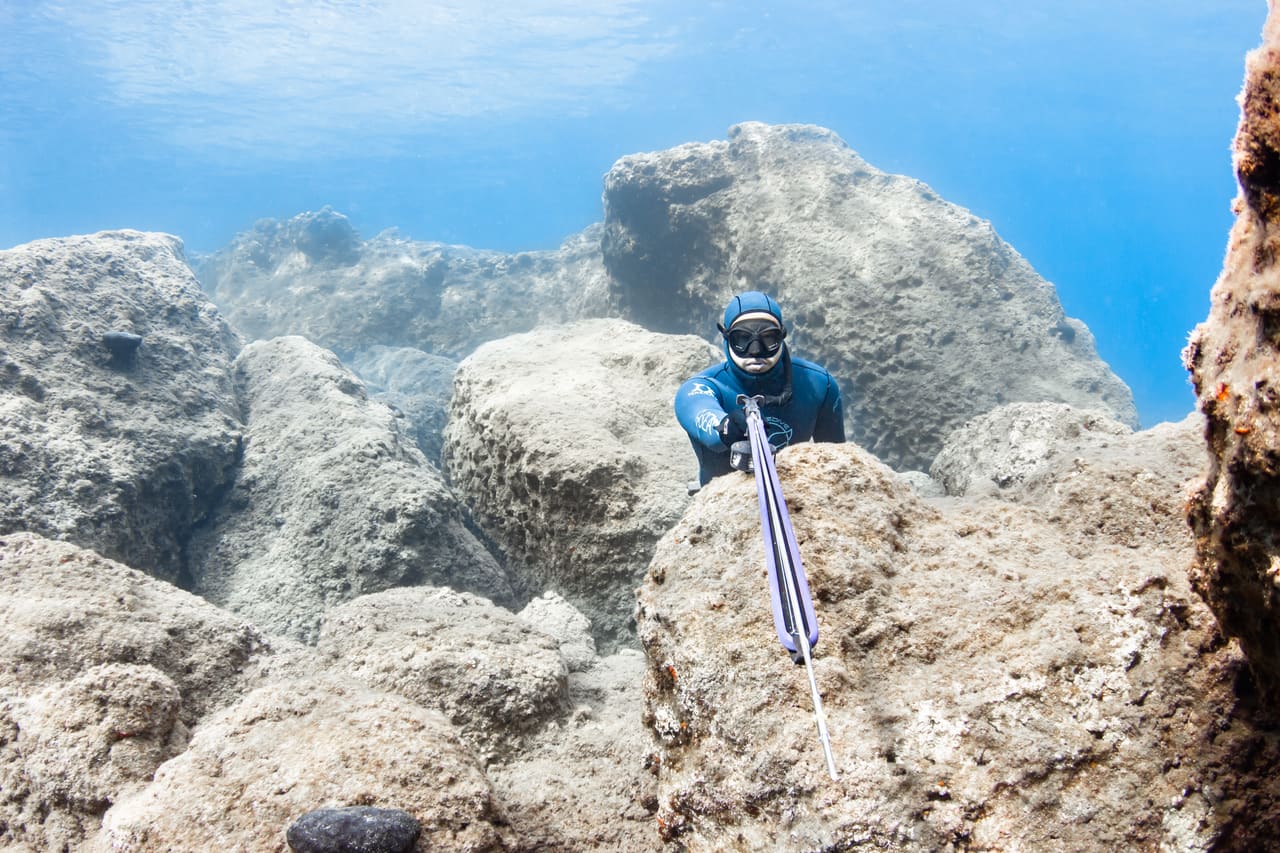 Spearfisher diving along the Cretan coast