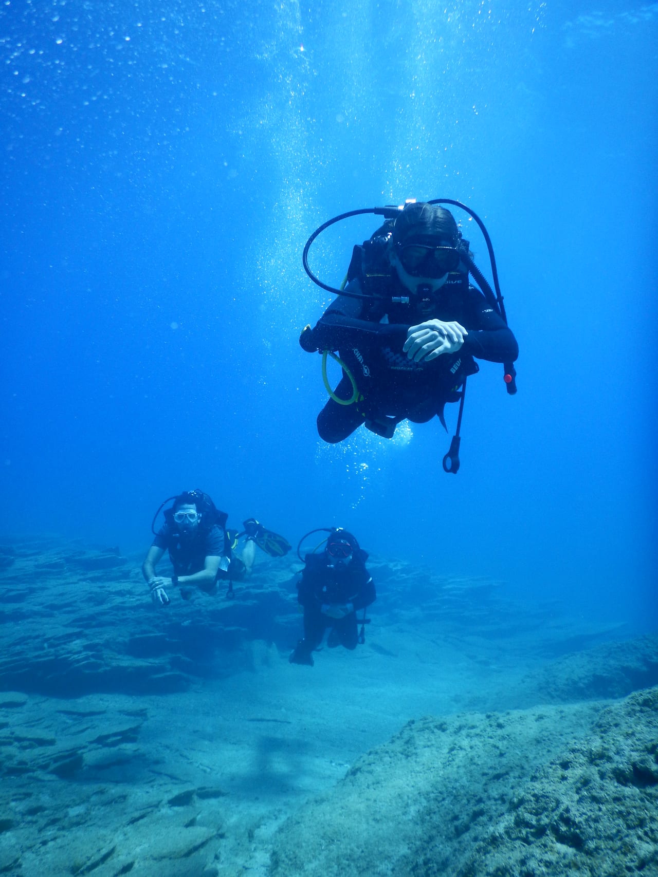 A diver reviewing course theory on a phone before a dive